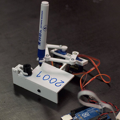 Here's a silly clock robot that writes the time, erases it, and updates it every minute